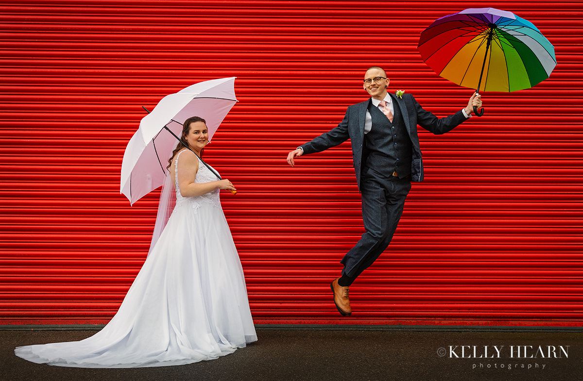 JON_bride-and-groom-umbrellas-red.jpg#asset:3019