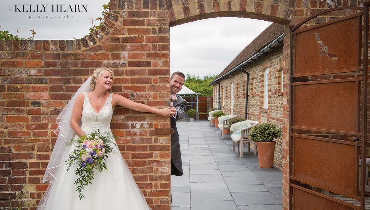 THO_bride-groom-holding-hands-under-archway.jpg#asset:2106