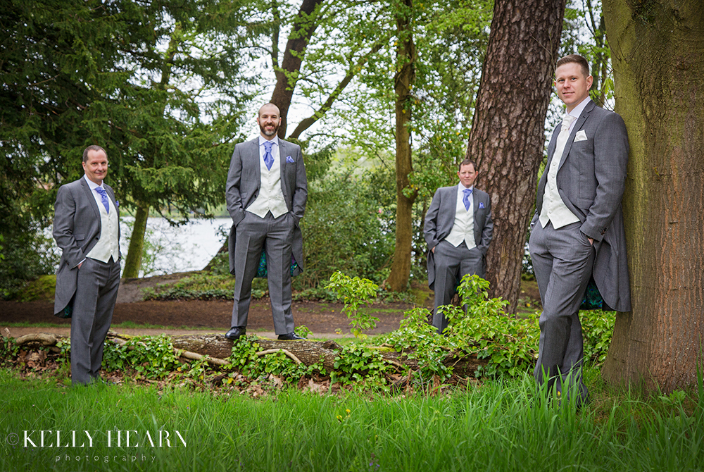 DOY_groom-groomsmen-leaning-against-trees.jpg#asset:2074