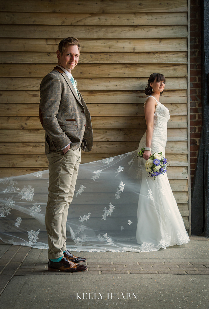 KLU_couple-outside-barn-wall-train-of-dress.jpg#asset:1707